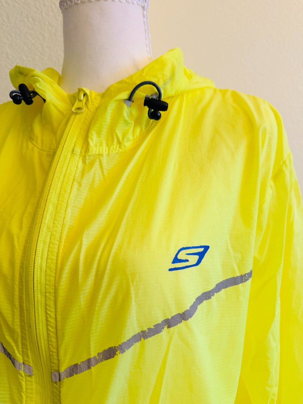 Sleek, wrinkle-free Neon Yellow Skechers Performance zip-up windbreaker